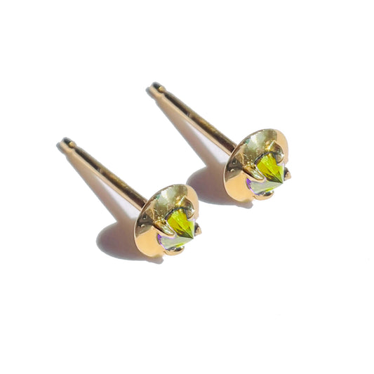 Yellow barbed diamond stud earrings on white background