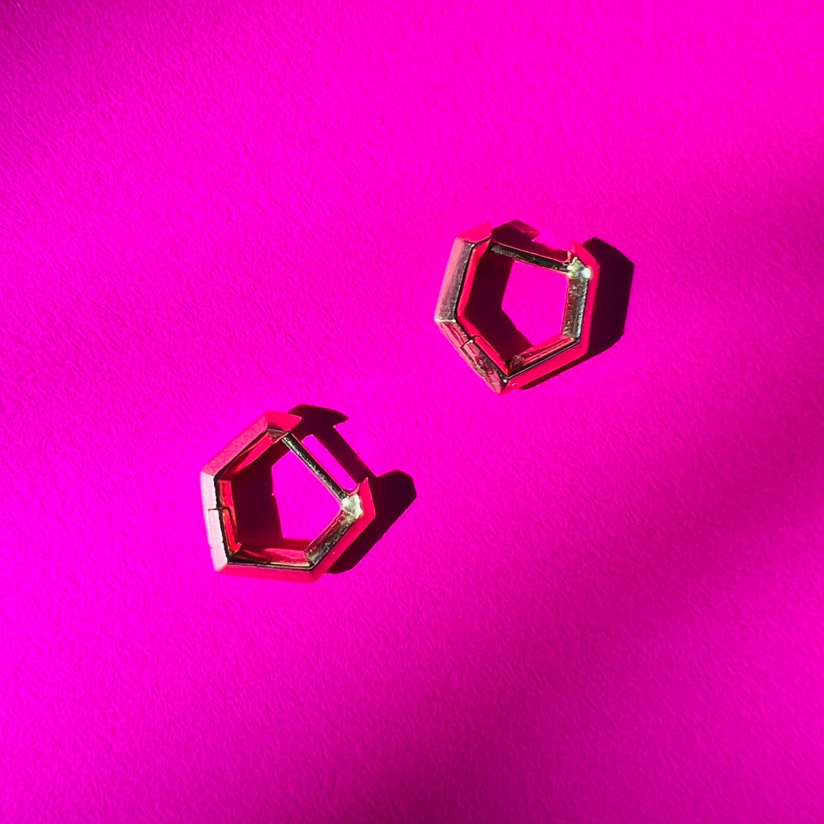 gold mini makhaira hoops on pink background