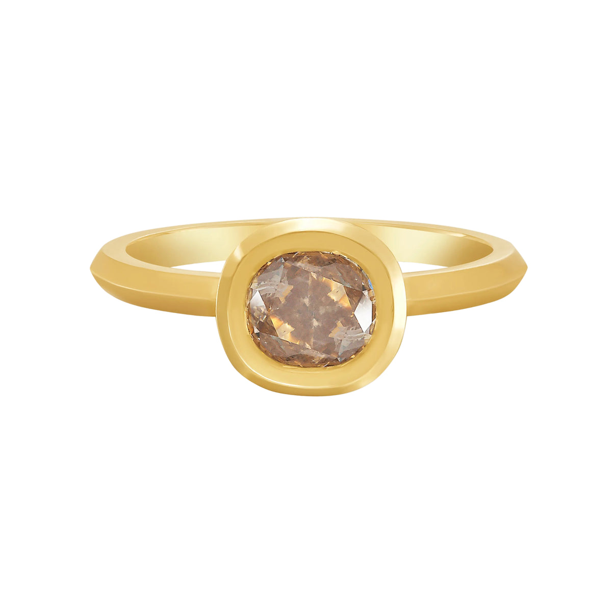 Gold bezel set solitaire ring with a cushion cut champagne color diamond on a white background by Tamsin Rasor