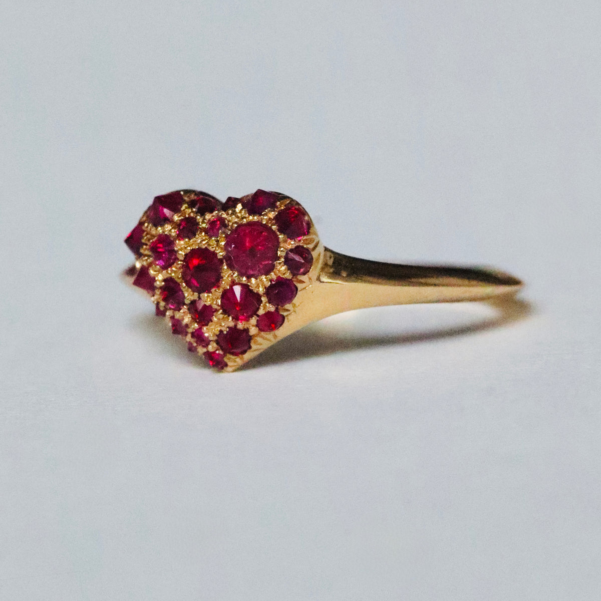 gold and spiked pavé ruby heart shaped signet ring by Tamsin Rasor, shown on white background