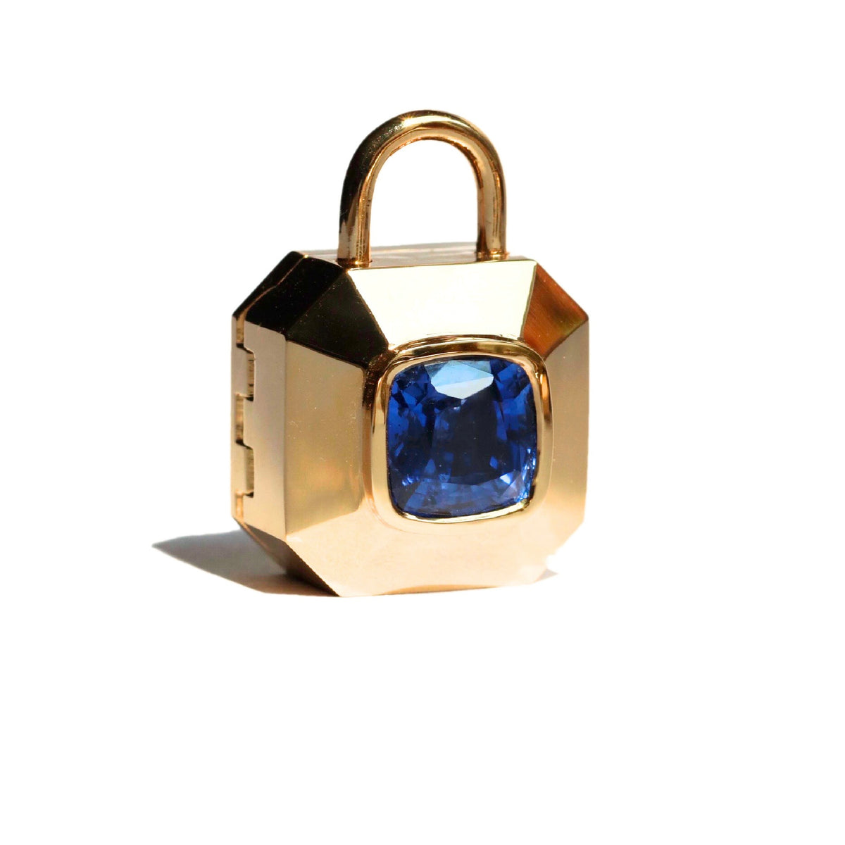 Gold padlock inspired locket pendant with blue sapphire center shown on a white background by Tamsin Rasor fine Jewelry