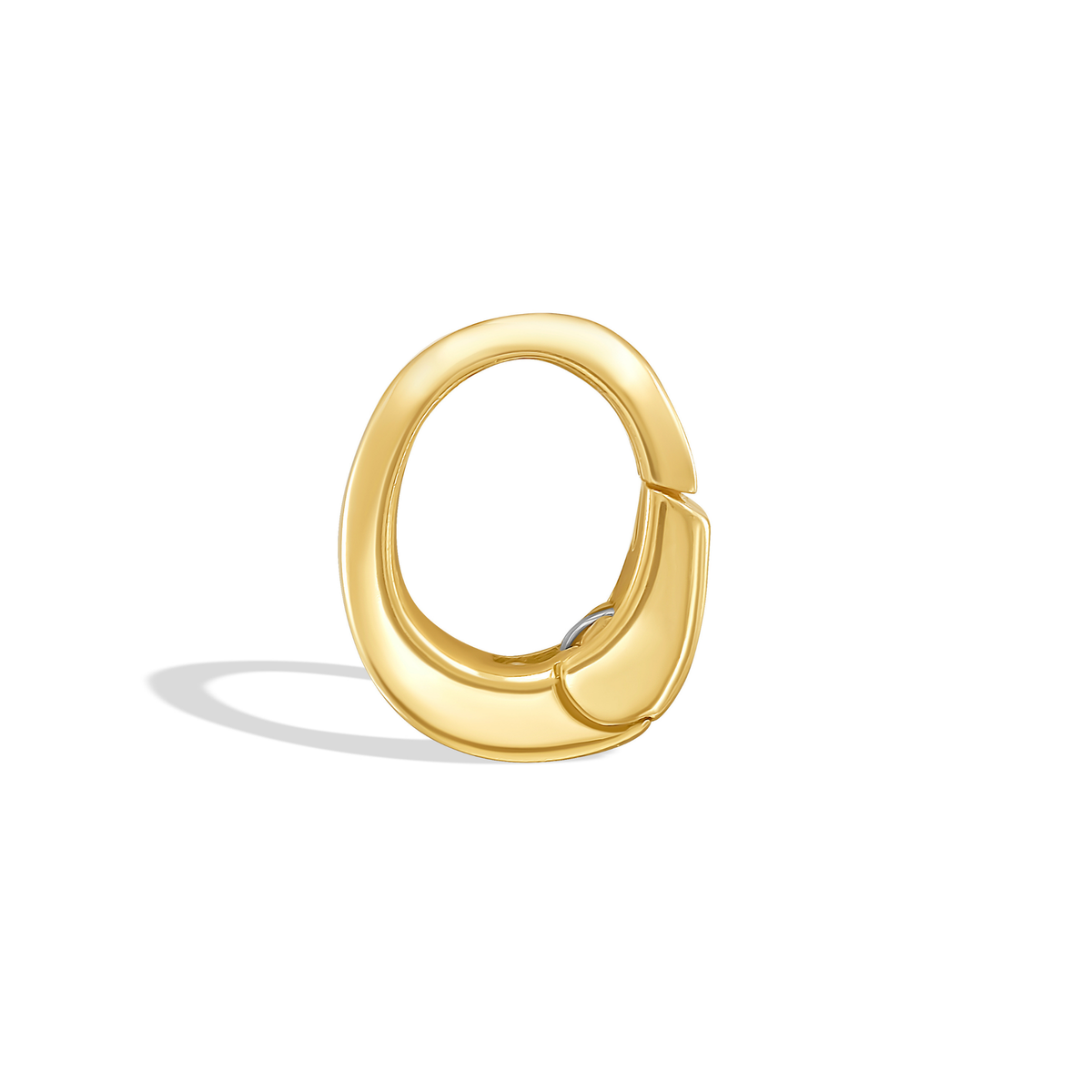 Gold oval shaped clip bail by Tamsin Rasor , photographed from side, on white background.