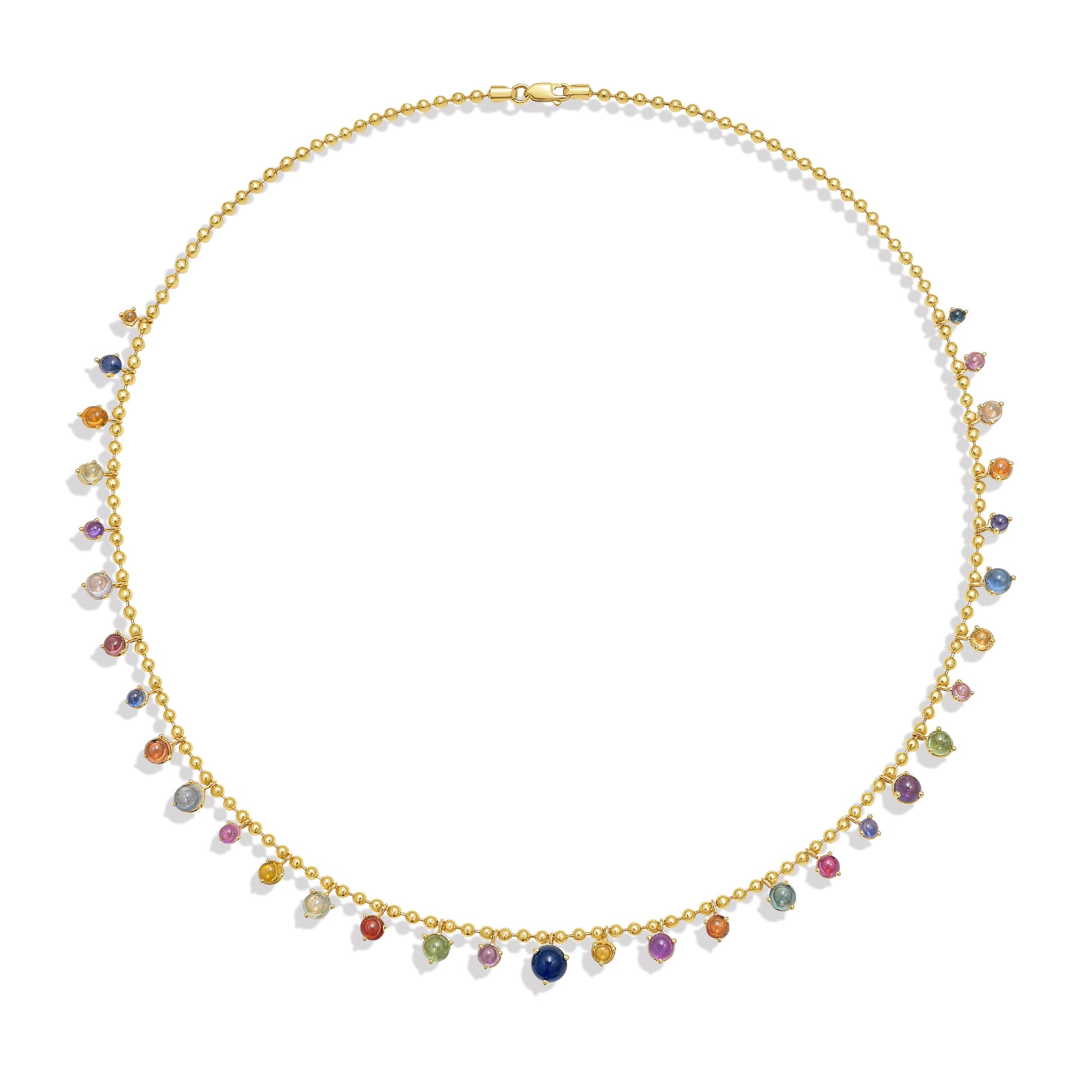 A gold bead chain necklace featuring a fringe of multi color sapphire cabochon gem drops, set in gold prong settings, arranged in a gentle curve against a white background with a soft shadow. By Tamsin Rasor