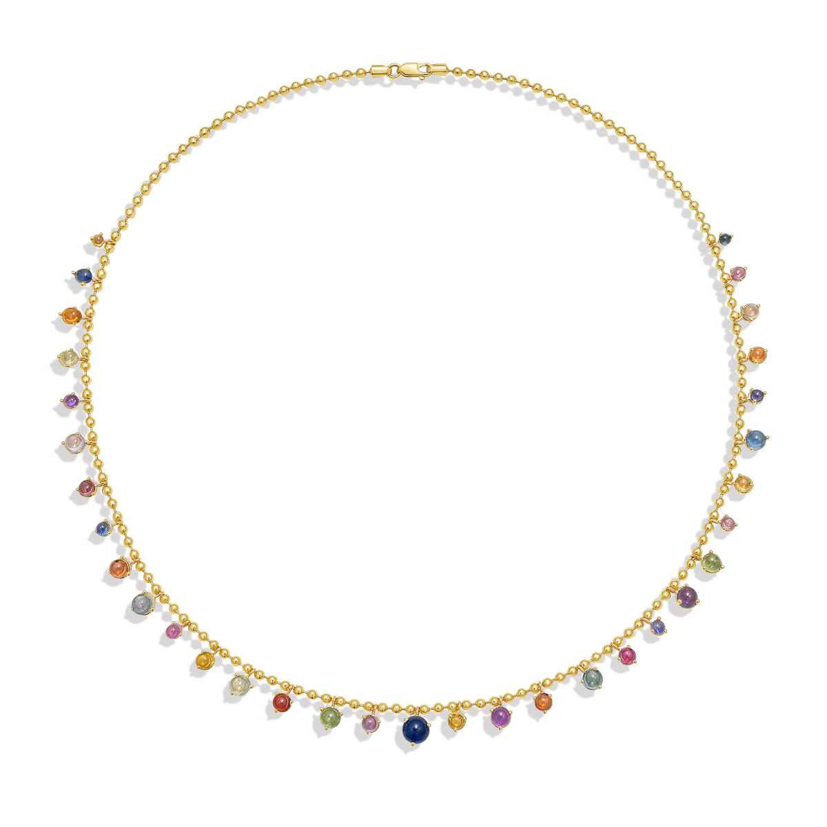 A gold bead chain necklace featuring a fringe of multi color sapphire cabochon gem drops, set in gold prong settings, arranged in a gentle curve against a white background with a soft shadow. By Tamsin Rasor