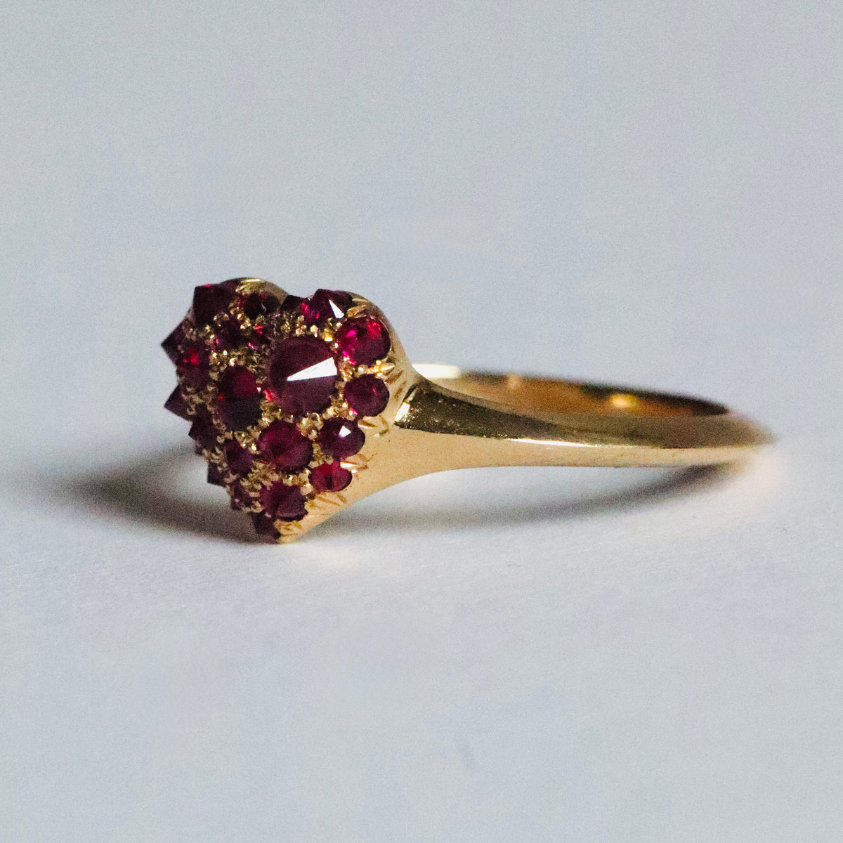 gold and pavé ruby heart shaped signet ring by Tamsin Rasor shown on white background