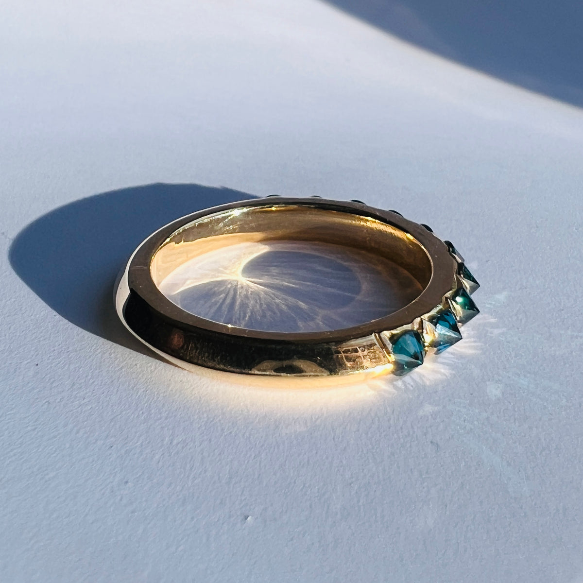Barbed Diamond half eternity in blue diamond on white background, by Tamsin Rasor, see from side
