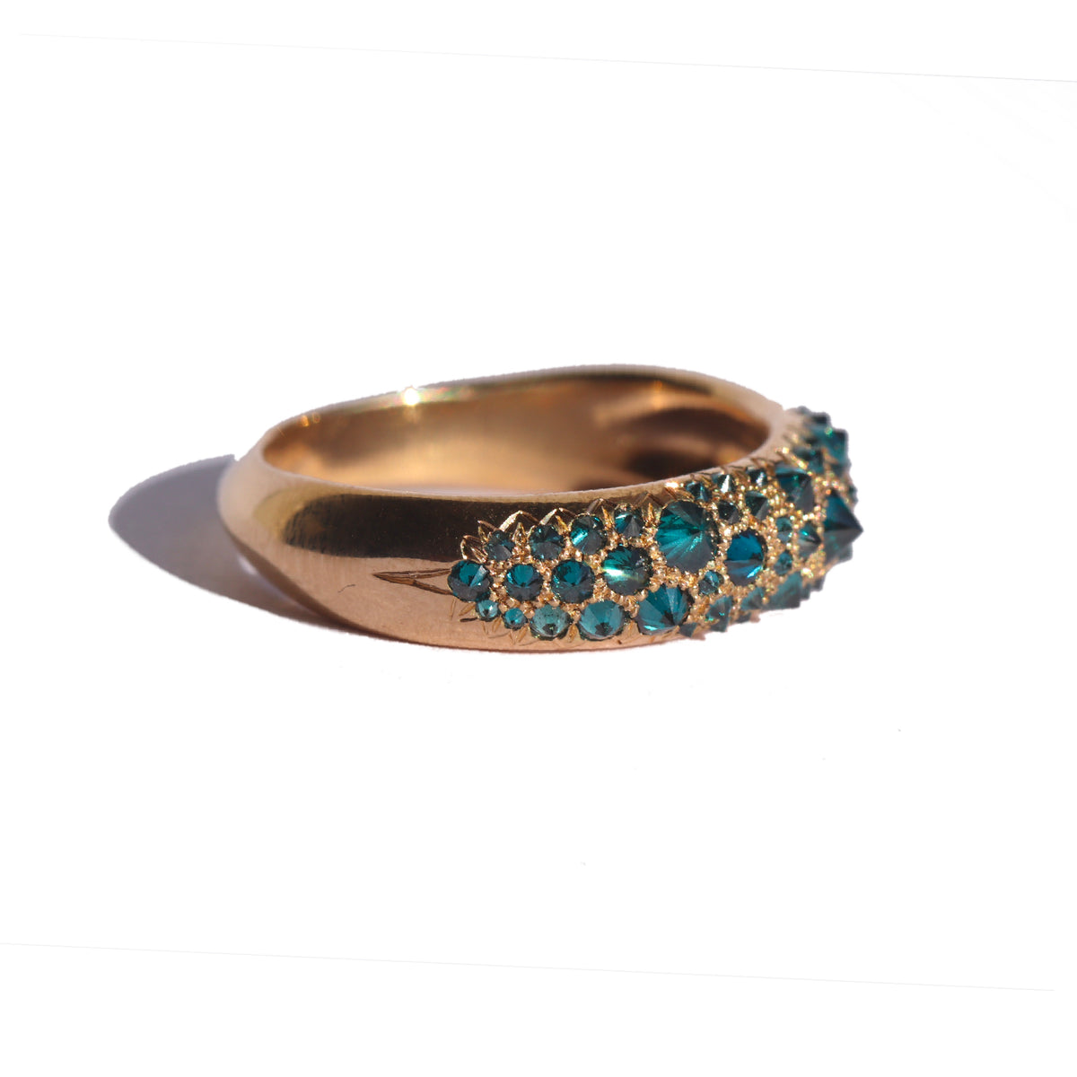 blue diamond and gold Duomo ring by Tamsin Rasor on white background seen from the side