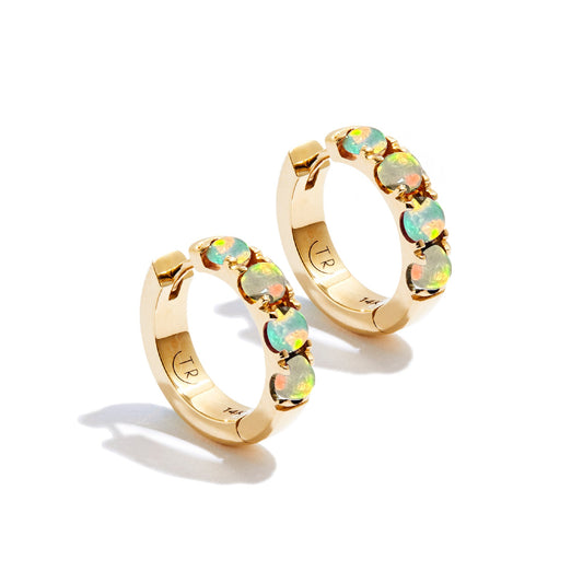 Opal and gold hoop earrings on white background
