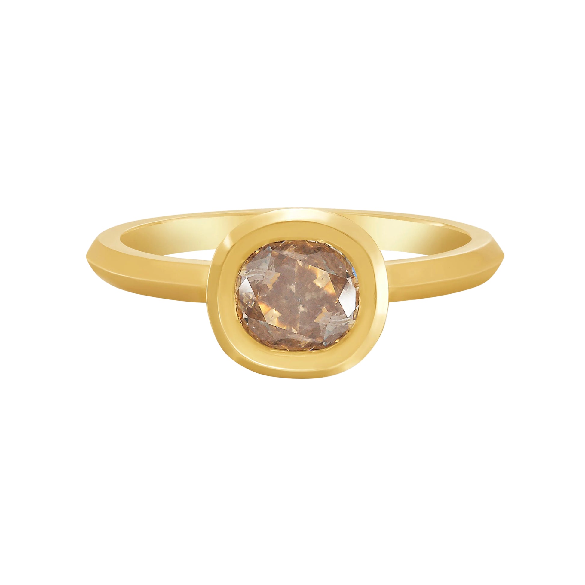 Gold bezel set solitaire ring with a cushion cut champagne color diamond on a white background by Tamsin Rasor