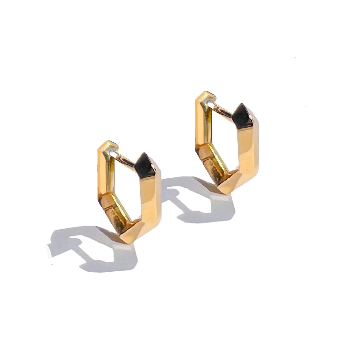 Solid gold Makhaira Mini Hoop earrings on white background