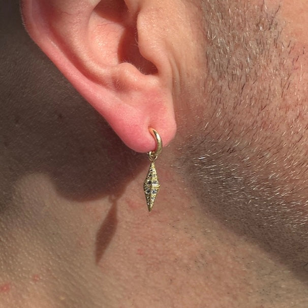 barbed diamond obelisk worn as an earring charm on a mini hoop earring on models ear