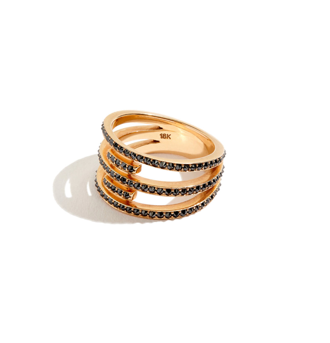 Three band Rose gold and black diamond ring on white background