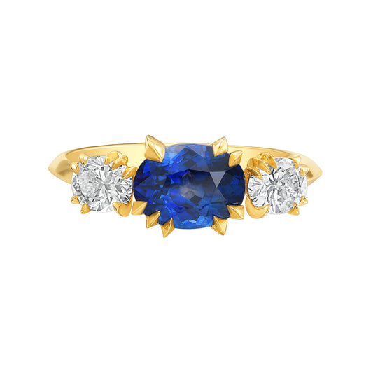 Gold, blue Sapphire and white diamond three stone, Trilogy ring by Tamsin Rasor on a white background