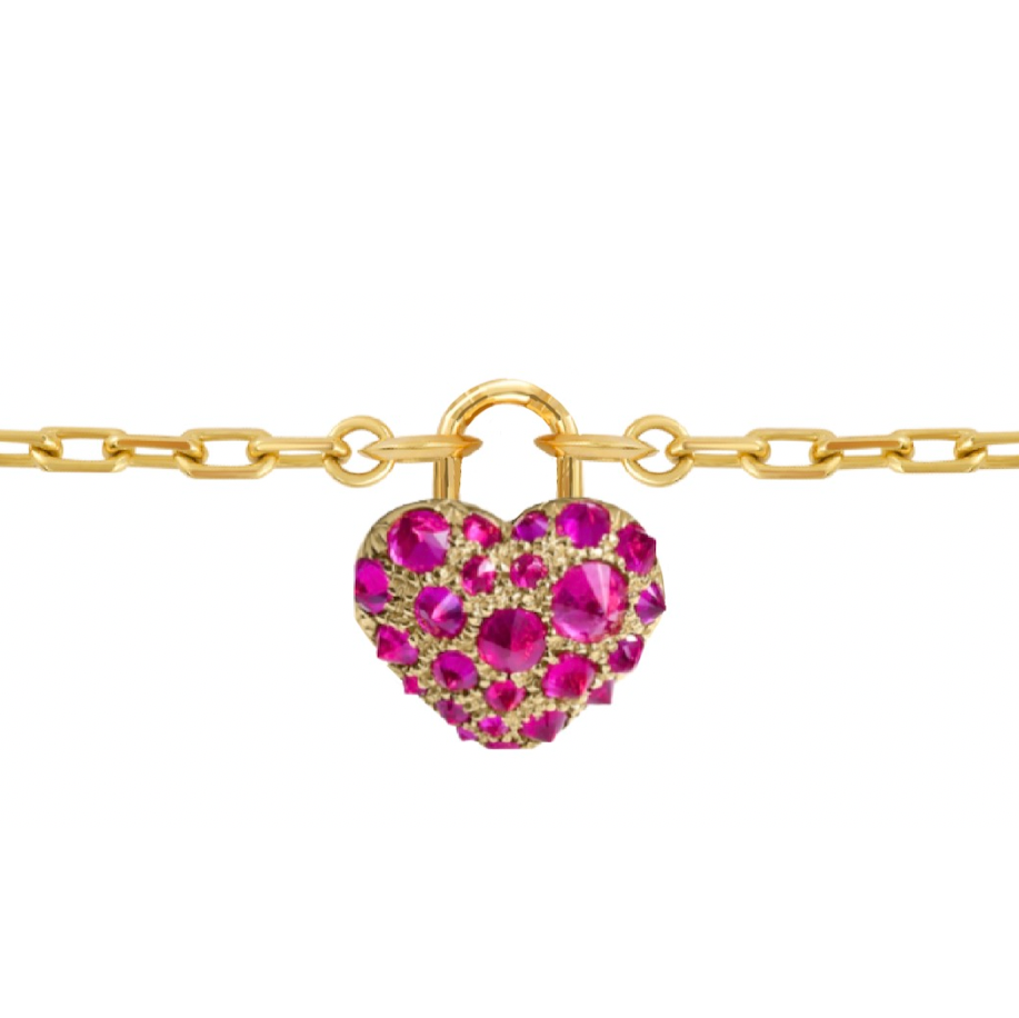 Gold bracelet with a heart-shaped ruby charm by Tamsin Rasor on a white background