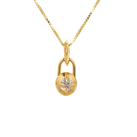 Mini gold and diamond compass necklace on white background by Tamsin Rasor