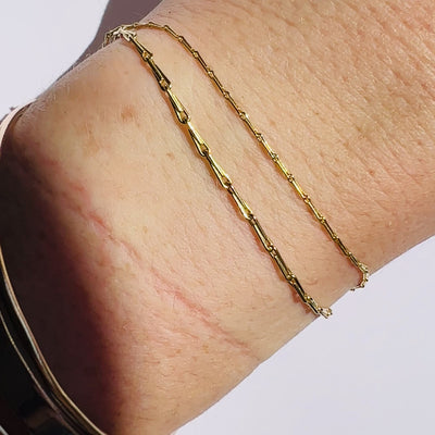 video of gold barley corn chain in 1mm and 1.7mm widths shown on models wrist against a white background by Tamsin Rasor Fine Jewelry