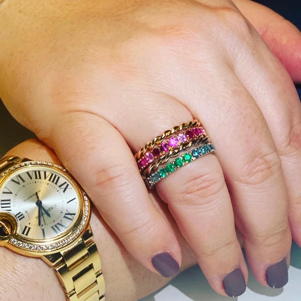 Solid Gold Twist Rings by Tamsin Rasor Fine Jewelry stacked with pink sapphire and emerald eternity rings on hand