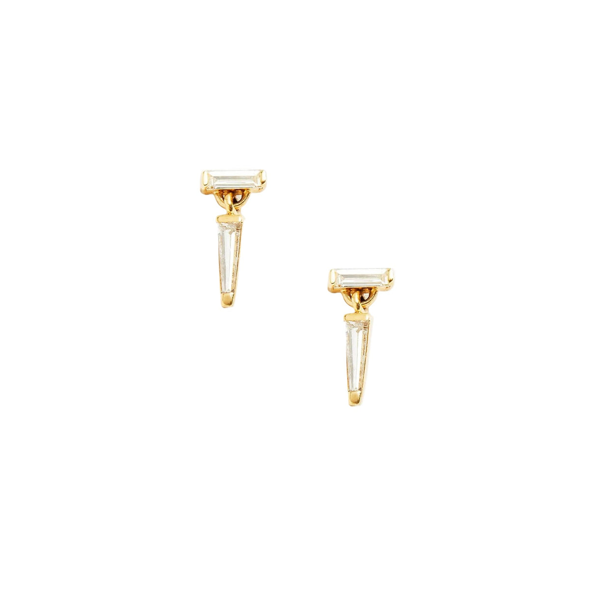 A pair of yellow gold drop earrings with baguette cut diamonds, by Tamsin Rasor, against white background